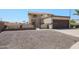 Two-story home featuring low-maintenance landscaping, an attached two-car garage, and a private, gated front entry at 10002 N 66Th Ln, Glendale, AZ 85302