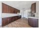 A renovated kitchen featuring dark wood cabinets, white countertops, and stainless-steel appliances at 10002 N 66Th Ln, Glendale, AZ 85302