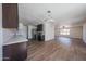 An inviting kitchen with a modern lighting fixture and stainless steel appliances with seamless access to the living areas at 10002 N 66Th Ln, Glendale, AZ 85302