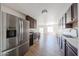 The kitchen features stainless steel appliances, lots of counter space, dark wood cabinets, and tile flooring at 10002 N 66Th Ln, Glendale, AZ 85302