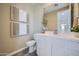 Well-lit half bathroom with a white vanity, neutral walls and decor at 10107 E Ulysses Ave, Mesa, AZ 85212