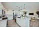 Bright modern kitchen boasts white cabinetry, stainless steel appliances, and island with pendant lighting at 10107 E Ulysses Ave, Mesa, AZ 85212