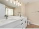 Bathroom featuring a double vanity with white cabinets and modern fixtures at 12426 W Adams St, Avondale, AZ 85323