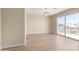 Open bedroom with a sliding glass door to the balcony and wood floors at 12426 W Adams St, Avondale, AZ 85323