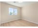 Light and airy bedroom featuring a large window with a view of palm trees and light-colored flooring at 12426 W Adams St, Avondale, AZ 85323