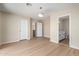 Bright bedroom with neutral walls, wood-look floors, and a stylish light fixture at 12426 W Adams St, Avondale, AZ 85323