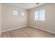 Bright bedroom with light wood-look floors and three windows offering ample natural light at 12426 W Adams St, Avondale, AZ 85323