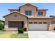 Exterior front view of a two-story home featuring a two-car garage and desert landscaping at 12426 W Adams St, Avondale, AZ 85323