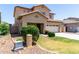 Two-story home with desert landscaping, a two-car garage and well-maintained lawn at 12426 W Adams St, Avondale, AZ 85323