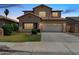 Two-story home featuring a well-kept lawn and two-car garage on a concrete driveway at 12426 W Adams St, Avondale, AZ 85323