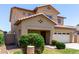 Inviting two-story home with a two-car garage, desert landscaping, and a well-kept lawn at 12426 W Adams St, Avondale, AZ 85323