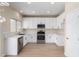 Well-lit kitchen featuring stainless steel appliances, white cabinets and quartz countertops at 12426 W Adams St, Avondale, AZ 85323