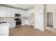 Updated kitchen featuring stainless steel appliances, white cabinets and quartz countertops at 12426 W Adams St, Avondale, AZ 85323