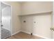 Bright laundry room with overhead shelf and adjacent door frame at 12426 W Adams St, Avondale, AZ 85323
