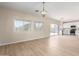 Bright living room featuring wood floors, recessed lighting and a sliding glass door to the backyard at 12426 W Adams St, Avondale, AZ 85323