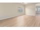 Large empty living room with new flooring, light walls and view into other rooms at 12426 W Adams St, Avondale, AZ 85323