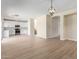 Open-concept living room with wood floors, recessed lighting and a view of the kitchen and staircase at 12426 W Adams St, Avondale, AZ 85323