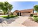 Front exterior showcasing the driveway, tile roof, mature landscaping, and an attached two-car garage at 1258 E Granada St, Mesa, AZ 85203