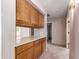 Hallway featuring wood cabinetry and countertop space, with a view into the kitchen and hallway into the other parts of the home at 1258 E Granada St, Mesa, AZ 85203