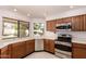 Charming kitchen with wood cabinets, stainless steel appliances, a garden view, and plenty of natural light at 1258 E Granada St, Mesa, AZ 85203