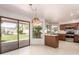 Eat-in kitchen with natural light, wood cabinets, stainless appliances, and access to the backyard through sliding glass doors at 1258 E Granada St, Mesa, AZ 85203