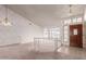 Open-concept living area featuring large windows, a decorative chandelier, a light color scheme, and tile entryway at 1258 E Granada St, Mesa, AZ 85203