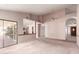 Bright living room featuring high ceilings, a ceiling fan, and sliding glass doors to the outside patio at 1258 E Granada St, Mesa, AZ 85203