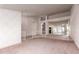 Open-concept living area featuring unique mirrored wall, an elegant chandelier, and access to multiple rooms at 1258 E Granada St, Mesa, AZ 85203