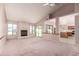 Cozy living room with a fireplace, large windows with backyard view, and a seamless transition to the kitchen at 1258 E Granada St, Mesa, AZ 85203