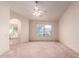 Spacious main bedroom with large window and an arched entrance to the main bath and walk-in closet at 1258 E Granada St, Mesa, AZ 85203
