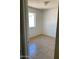 Serene bedroom featuring a window, neutral paint, and tile flooring at 13208 N 51St Ln, Glendale, AZ 85304