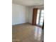 A bright, airy bedroom with tile flooring, neutral walls, and access to the backyard through glass patio doors at 13208 N 51St Ln, Glendale, AZ 85304