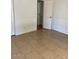 Inviting bedroom featuring tiled floors, light walls, and a closet with a white paneled door at 13208 N 51St Ln, Glendale, AZ 85304