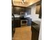 Updated kitchen boasts stainless steel appliances, dark wood cabinets, and stone countertops at 13208 N 51St Ln, Glendale, AZ 85304