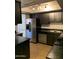 Updated kitchen features dark cabinets, granite countertops, and stainless-steel appliances at 13208 N 51St Ln, Glendale, AZ 85304