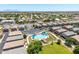 Aerial view of the community featuring a pool, clubhouse, parking, and well-maintained landscaping at 1350 S Greenfield Rd # 2205, Mesa, AZ 85206