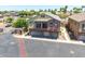 Aerial view of a multi-story home with a three-car garage, balcony, and well-maintained landscaping at 1350 S Greenfield Rd # 2205, Mesa, AZ 85206