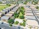 Aerial view of a neighborhood showcasing well-maintained townhomes and green spaces at 1350 S Greenfield Rd # 2205, Mesa, AZ 85206