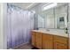 Bathroom featuring a vanity with cabinet storage and a shower/tub combination with a decorative shower curtain at 1350 S Greenfield Rd # 2205, Mesa, AZ 85206