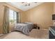 Bedroom featuring a ceiling fan and a window with a view to the front yard at 1350 S Greenfield Rd # 2205, Mesa, AZ 85206
