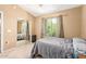 Bright bedroom with large window, mirrored closet doors, and neutral carpeting, creating a serene retreat at 1350 S Greenfield Rd # 2205, Mesa, AZ 85206