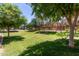 Expansive greenbelt area offers manicured landscaping with walking paths and mature trees at 1350 S Greenfield Rd # 2205, Mesa, AZ 85206