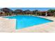 Community pool with clear blue water, lounge chairs, and covered seating areas at 1350 S Greenfield Rd # 2205, Mesa, AZ 85206