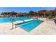 Community pool and spa with accessible handrails surrounded by lounge chairs at 1350 S Greenfield Rd # 2205, Mesa, AZ 85206