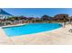 Community pool with clear blue water, lounge chairs, and covered seating areas at 1350 S Greenfield Rd # 2205, Mesa, AZ 85206