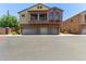 Three-story home with three-car garage featuring stone accents and a lovely red window box at 1350 S Greenfield Rd # 2205, Mesa, AZ 85206