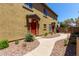 Charming home featuring a bright red front door and nicely landscaped front yard at 1350 S Greenfield Rd # 2205, Mesa, AZ 85206