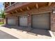 A nice view of the three-car garage with beautiful stone accents and decorative lighting at 1350 S Greenfield Rd # 2205, Mesa, AZ 85206
