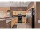 Well-lit kitchen featuring stainless steel appliances, ample cabinetry, and a convenient breakfast bar area at 1350 S Greenfield Rd # 2205, Mesa, AZ 85206