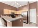 Spacious kitchen featuring stainless steel appliances, ample cabinet space, and a functional breakfast bar area at 1350 S Greenfield Rd # 2205, Mesa, AZ 85206